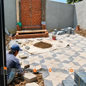 Pekerja Memasang Paving Geometris di Halaman